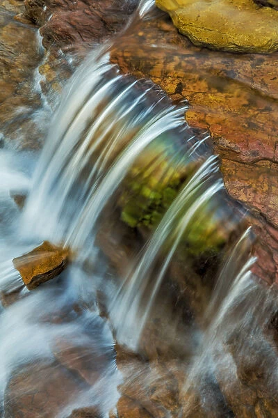 Colorful cascade on Oberlin Creek in Glacier National Park, Montana, USA