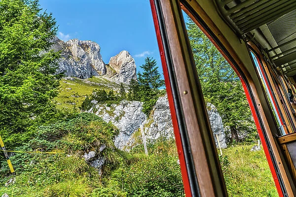 Colorful cogwheel rail car climbing Mount Pilatus, Lucerne, Switzerland