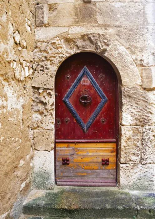 Framed Print : Colorful door in the stone wall of a chateau in France Framed Print : Colorful door in the stone wall of a chateau in France