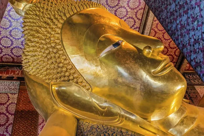 Framed Print : Colorful face Reclining Buddha, Wat Pho Temple, Bangkok, Thailand. Temple built in 1600's. Reclining Buddha built in 1832. Face reflects Buddha entry into heaven nirvana final goal of Buddhism