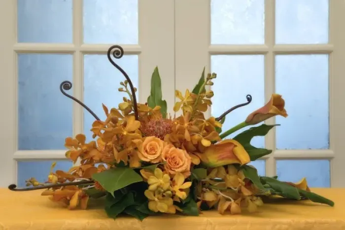 Framed Print : Colorful flower arrangement on table in front of door Framed Print : Colorful flower arrangement on table in front of door