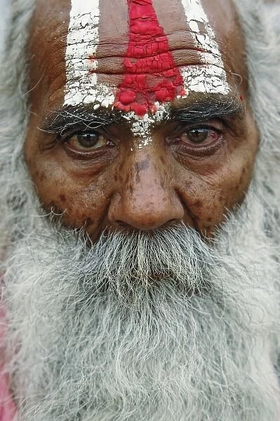 Colorful old man with long beard at train station in Udaipur, India