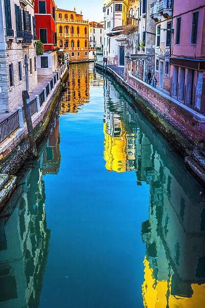 Colorful small canal creating beautiful reflection in Venice, Italy