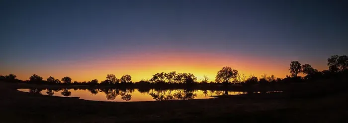 Framed Print : Colorful sunset at watering hole. Camelthorn Lodge. Hwange National Park. Zimbabwe Framed Print : Colorful sunset at watering hole. Camelthorn Lodge. Hwange National Park. Zimbabwe