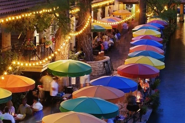 Colorful umbrellas of outdoor cafe along famous River Walk and San Antonio River