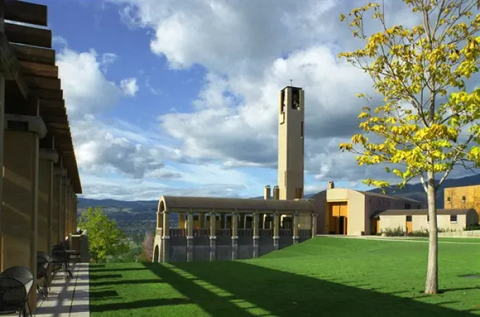 Framed Print : The concrete bell tower seems to touch the clouds in a blue sky over the architecturally