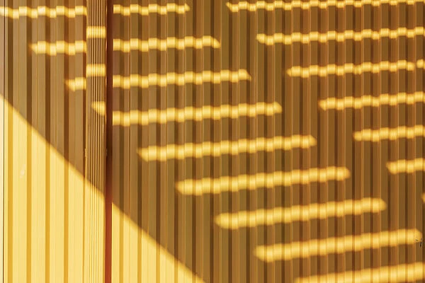Coney Island, Brooklyn, New York, USA. Striped shadows on a yellow building