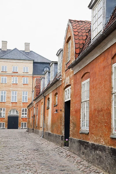 Copenhagen, Denmark - An image of an old world, cobblestone street and surrounding buildings