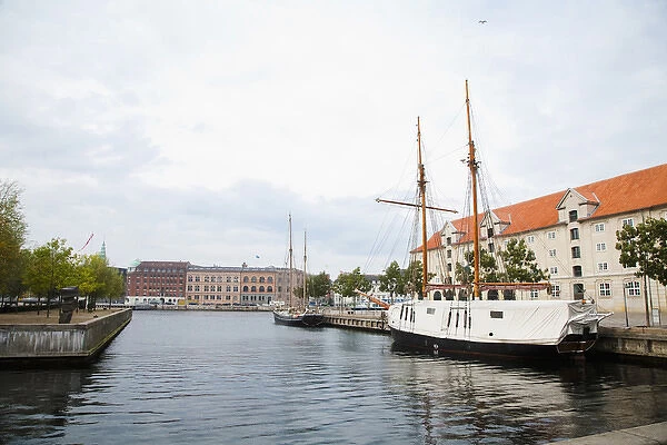 Copenhagen, Denmark - On old world, waterfront city. A boat are viewable on the water