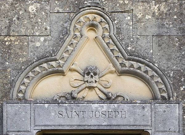 Corsica. France. Europe. Bas-relief skull above door to mausoleum adjacent to Cathedral of Nebbio