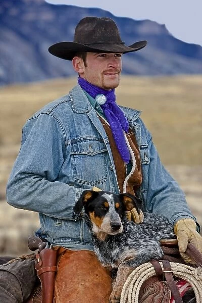 A cowboy and his dog sitting on his horse in the Big Horn MT of Wyoming
