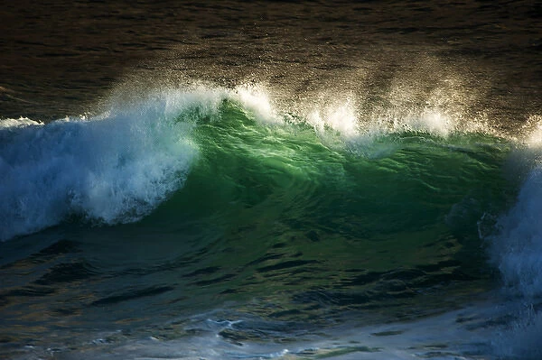 crashing wave with translucent green and spray