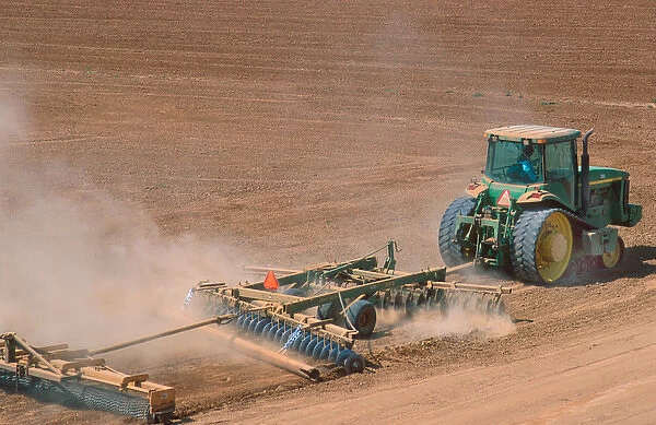 Crawler type tractor discing a field in preparation for planting in the Central Valley