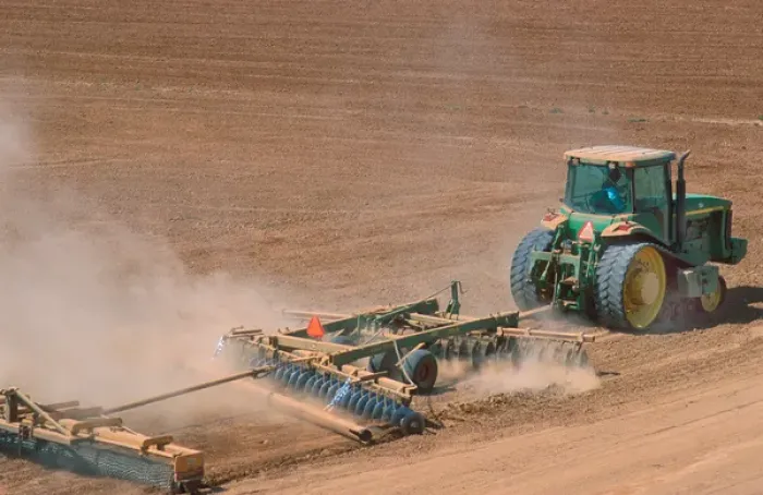 Framed Print : Crawler type tractor discing a field in preparation for planting in the Central Valley Framed Print : Crawler type tractor discing a field in preparation for planting in the Central Valley