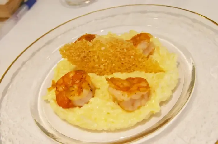 Framed Print : A creamy risotto with confit lemon and thyme grilled scampis on a glass plate with