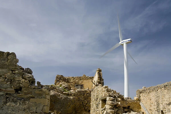 Crete. Greece. Europe. Wind turbine of Plastika Kritis wind farm towers above ruins