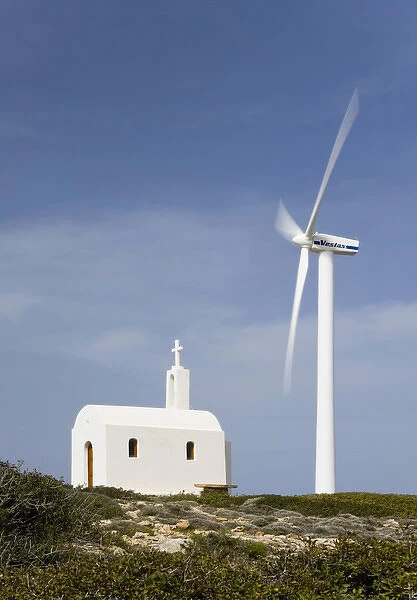 Crete. Greece. Europe. Wind turbine of Plastika Kritis wind farm towers above Church Agios Ioannis