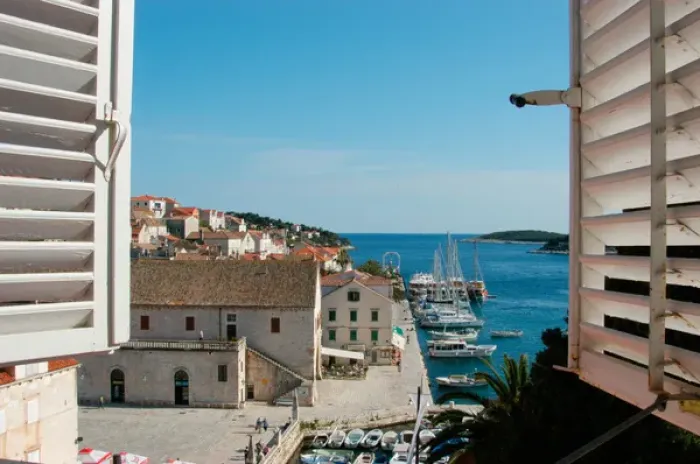 Framed Print : Croatia, Dalmatian Coast, Hvar, view of the harbor, boats and Riva seen thru shuttered Framed Print : Croatia, Dalmatian Coast, Hvar, view of the harbor, boats and Riva seen thru shuttered