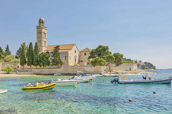 Croatia, Hvar. Franciscan monastery and boats in harbor