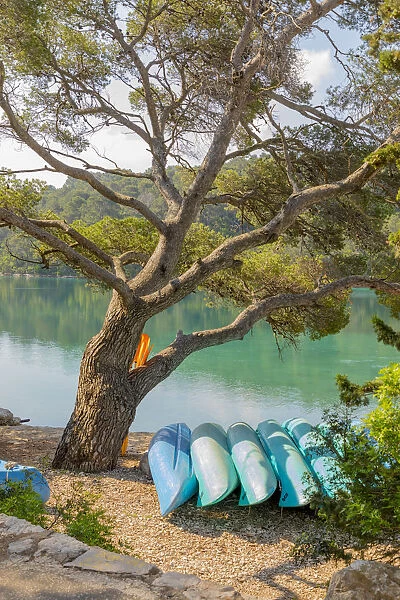 Croatia, Pomena. Canoes for rent on Island of Miljet