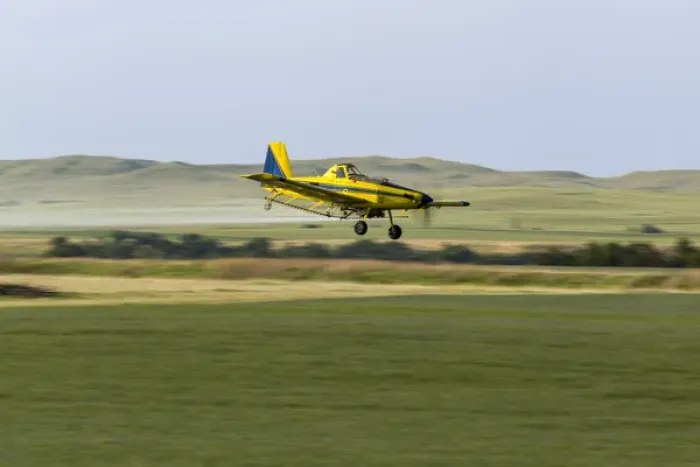 Framed Print : Crop Duster airplane spraying flax filed for grasshoppers near Mott, North Dakota, USA Framed Print : Crop Duster airplane spraying flax filed for grasshoppers near Mott, North Dakota, USA