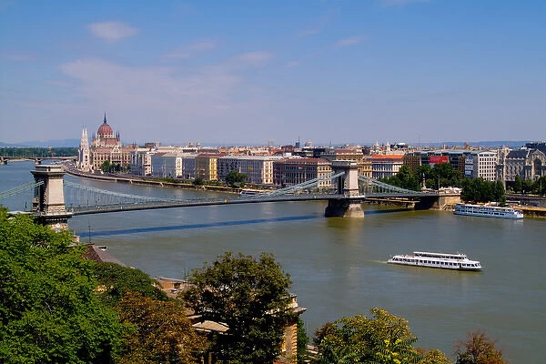 Cruise river boat taken from hill overlooking Chain Bridge Danube River and Parliament