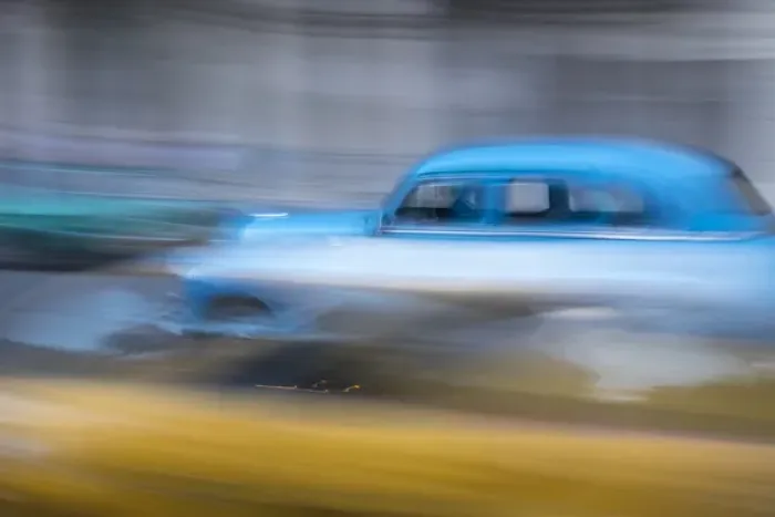 Framed Print : Cuba, Havana. Classic cars speed by in a blur along the streets of the city Framed Print : Cuba, Havana. Classic cars speed by in a blur along the streets of the city