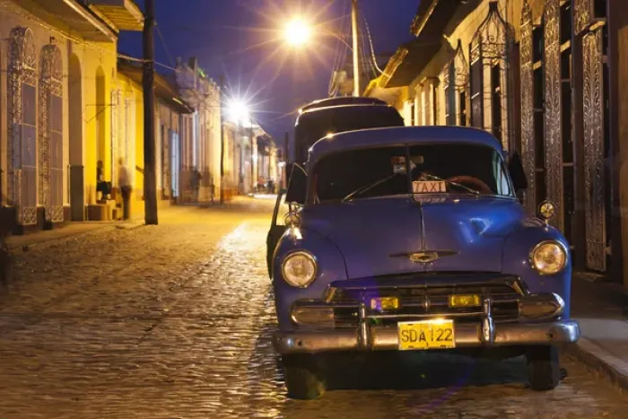 Framed Print : Cuba, Sancti Spiritus Province, Trinidad, taxis on Calle Antonio Maceo, dusk