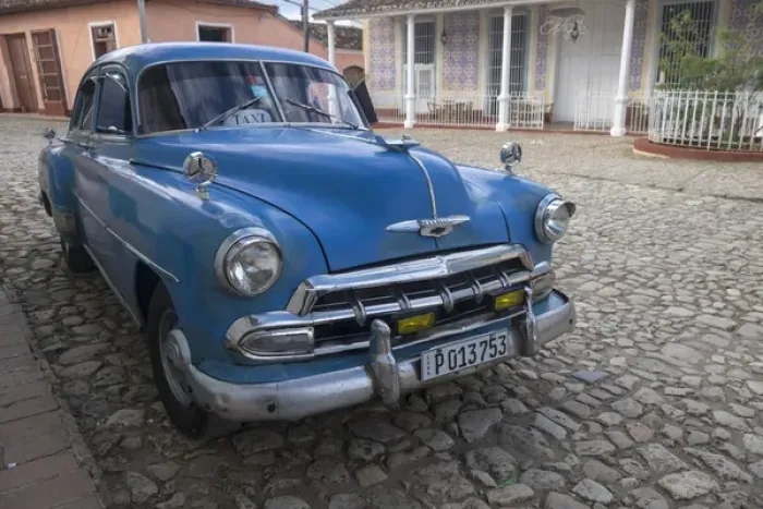 Framed Print : Cuba, Trinidad. Blue taxi parked on cobblestones