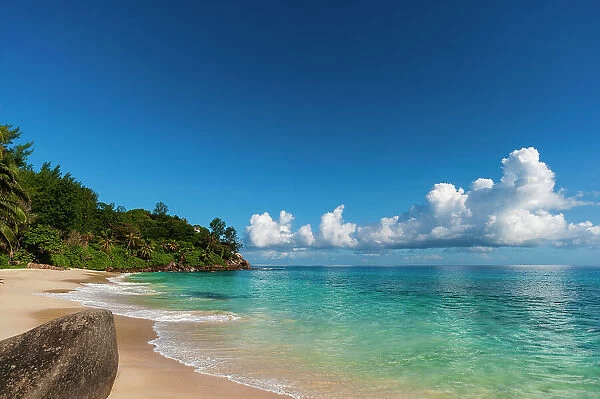Cumulus clouds off the shore of a pristine tropical beach. Mahe Island, The Republic of Seychelles