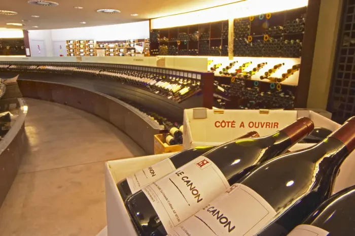 Framed Print : A curved display of bottles. In the foreground bottles of Le Canon SARL La Grande