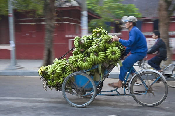 Cyclo loaded with bananas on the street