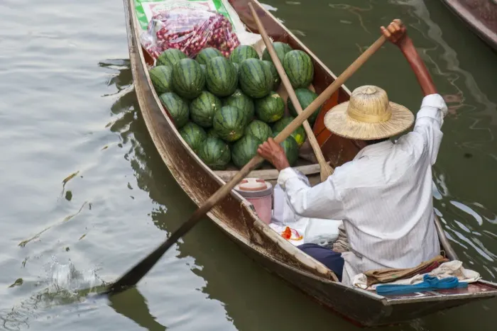 Framed Print : Damnoen Saduak Floating Market, Bangkok, Thailand. Man with a boatload of watermelons for Framed Print : Damnoen Saduak Floating Market, Bangkok, Thailand. Man with a boatload of watermelons for