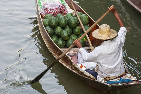 Damnoen Saduak Floating Market, Bangkok, Thailand. Man with a boatload of watermelons for