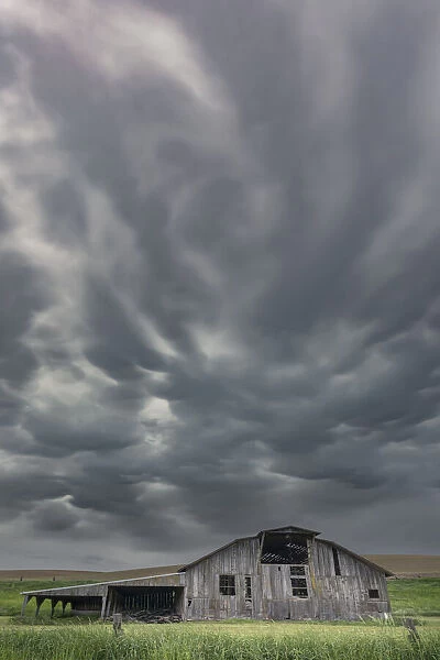 Dark, storm clouds above old barn, Palouse region of eastern Washington