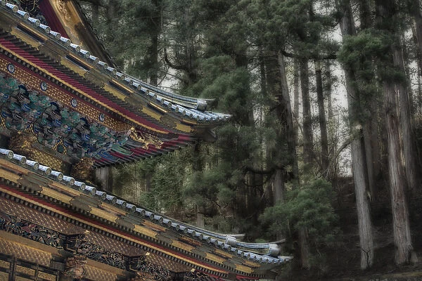 Decorative Japanese Temple roof against background of trees