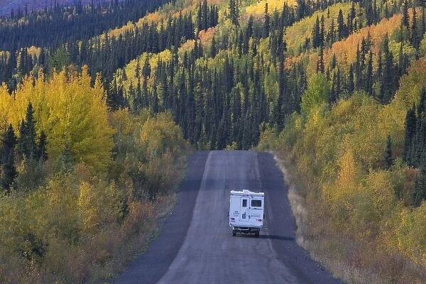 Dempster Highway winding through mountains and forests in fall colors, northern Yukon