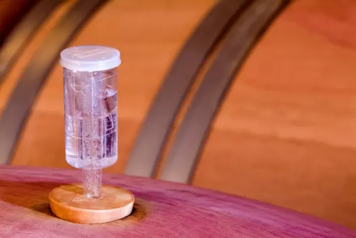Framed Print : A device that allows the CO2 (Carbon Dioxide) to escape the wine barrel and not allow Framed Print : A device that allows the CO2 (Carbon Dioxide) to escape the wine barrel and not allow