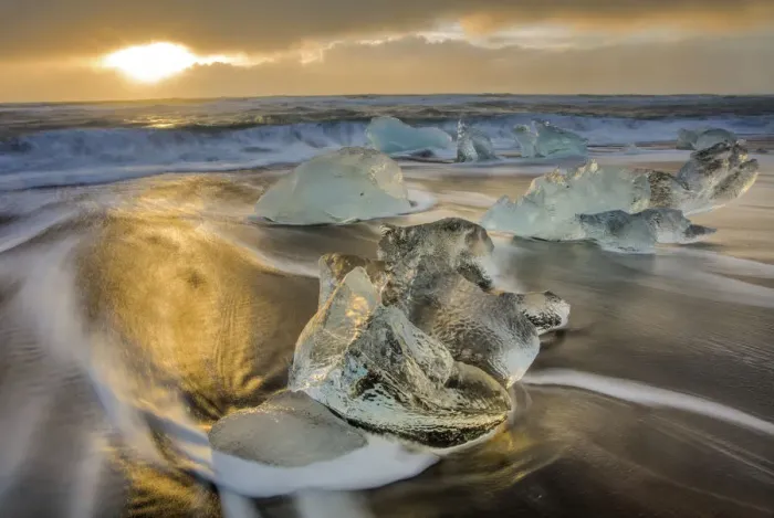 Framed Print : Diamond ice chards from calving icebergs on black sand beach at Jokulsarlon in south