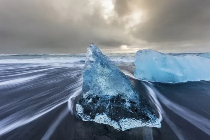 Framed Print : Diamond ice chards from calving icebergs on black sand beach at Jokulsarlon in south Framed Print : Diamond ice chards from calving icebergs on black sand beach at Jokulsarlon in south