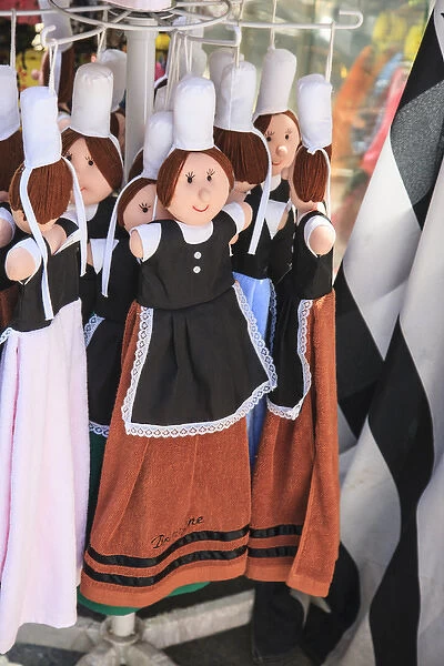These dolls are dressed in the tradional costume of the women of Brittany. Breton women wore a cap