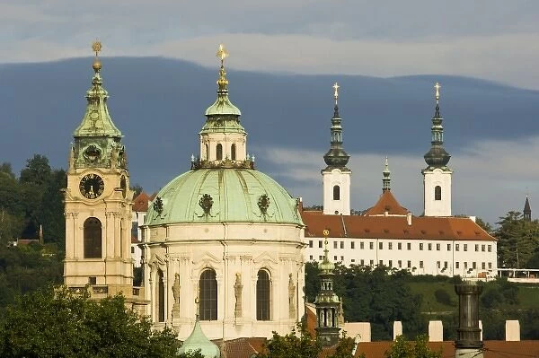 The dome and bell tower of the baroque church of St. Nicholas. Unknown building in the background
