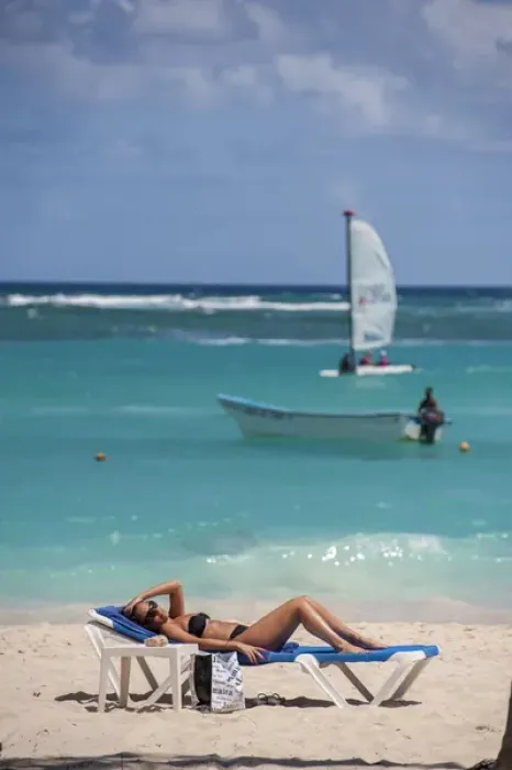 Framed Print : Dominican Republic, Punta Cana, Higuey, Bavaro, Bavaro Beach, young woman sunbathing