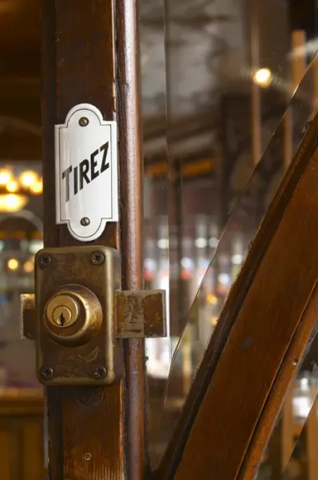 Framed Print : Detail of a door with a brass lock an enamel sign saying tirez (pull)