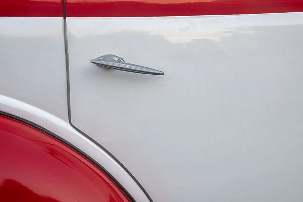 Detail of door on red and white classic American Ford in Habana, Havana, Cuba