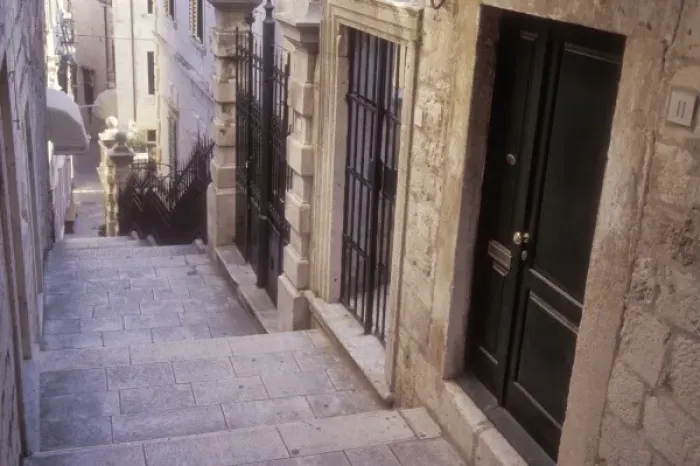 Framed Print : Doors to many homes line the narrow street in a residential area of Old Town Dubrovnik