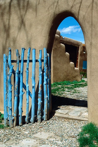 Doorway with gate in adobe house, Taos, New Mexico, USA