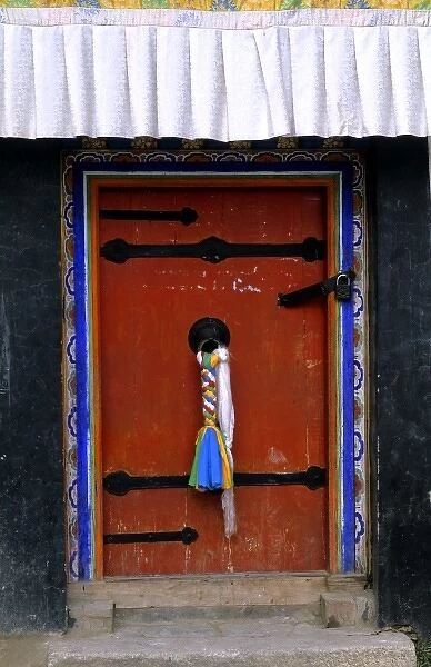 Doorway with welcome scarfs on knob of home in capital city of Lhasa Tibet China