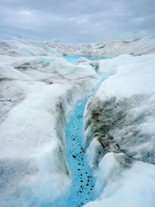 Framed Print : Drainage system on the surface of the ice sheet. The brown sediment on the ice is created by the rapid melting of the ice. Landscape of Greenland near Kangerlussuaq, Kingdom of Denmark