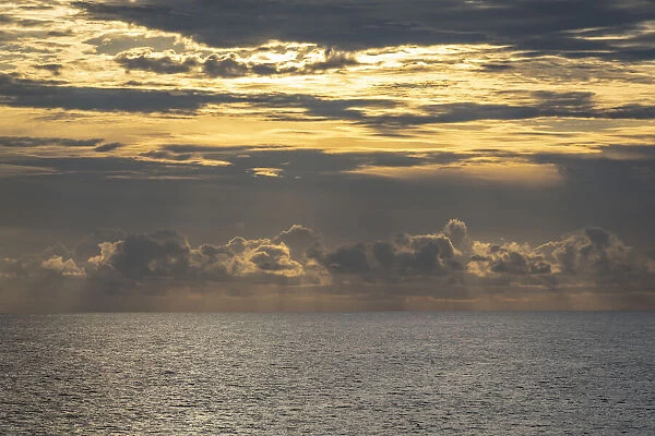 Dramatic skies, rain, sunbeams, sunset colors kiss the horizon of the Gulf of Mexico, Florida